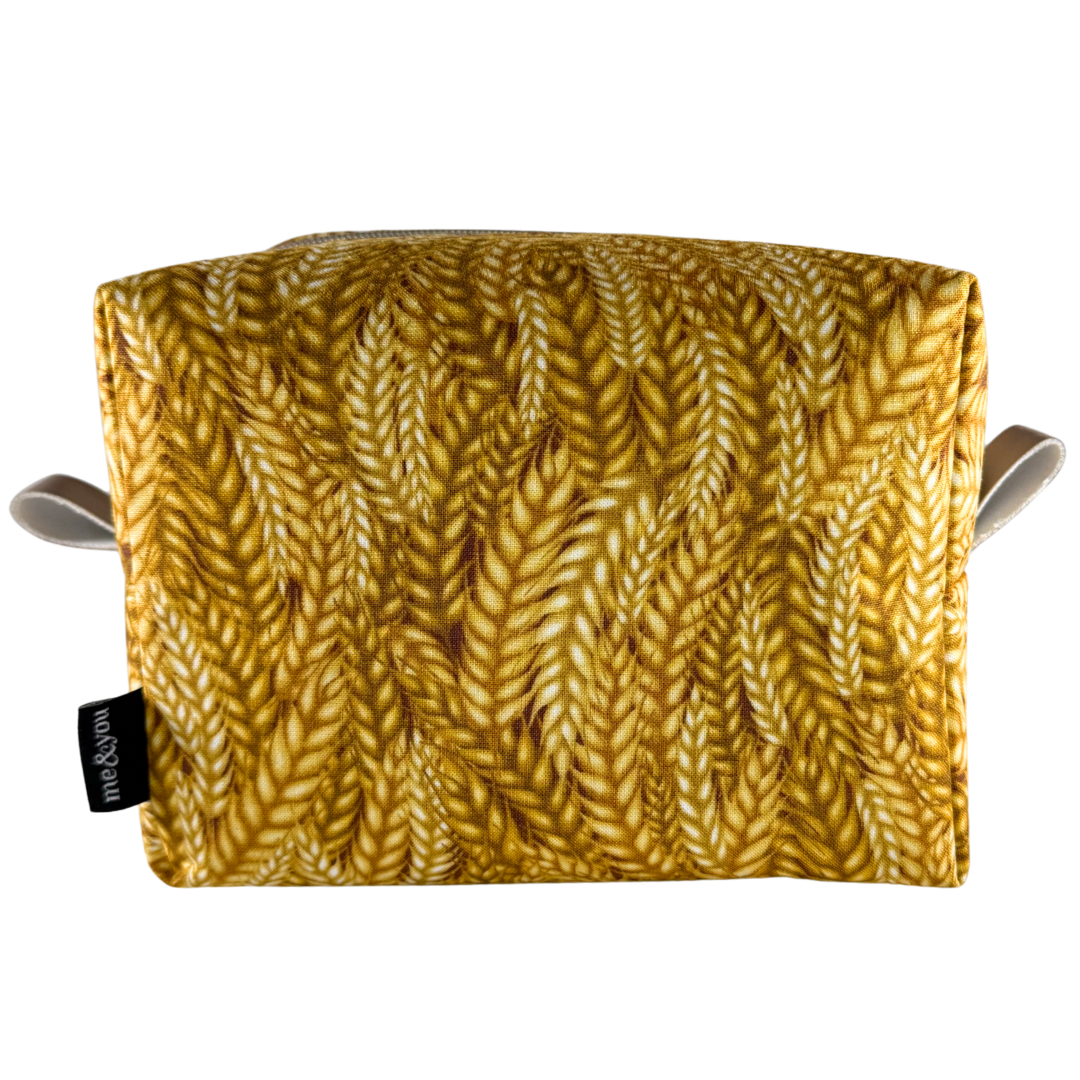 Yellow patterned pouch with a visible brand tag on a white background