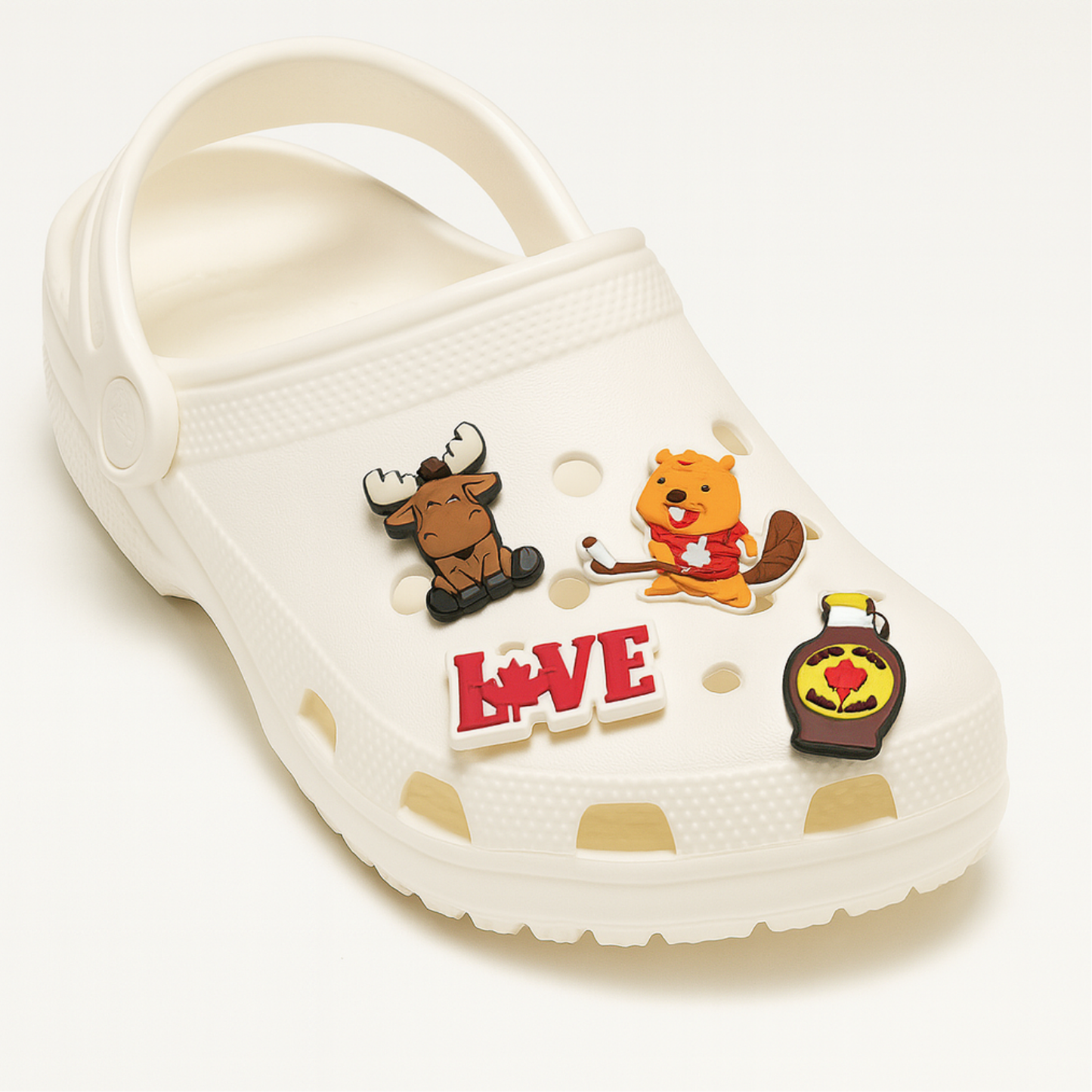 White clog shoe with moose, beaver, maple syrup, and LOVE charms attached