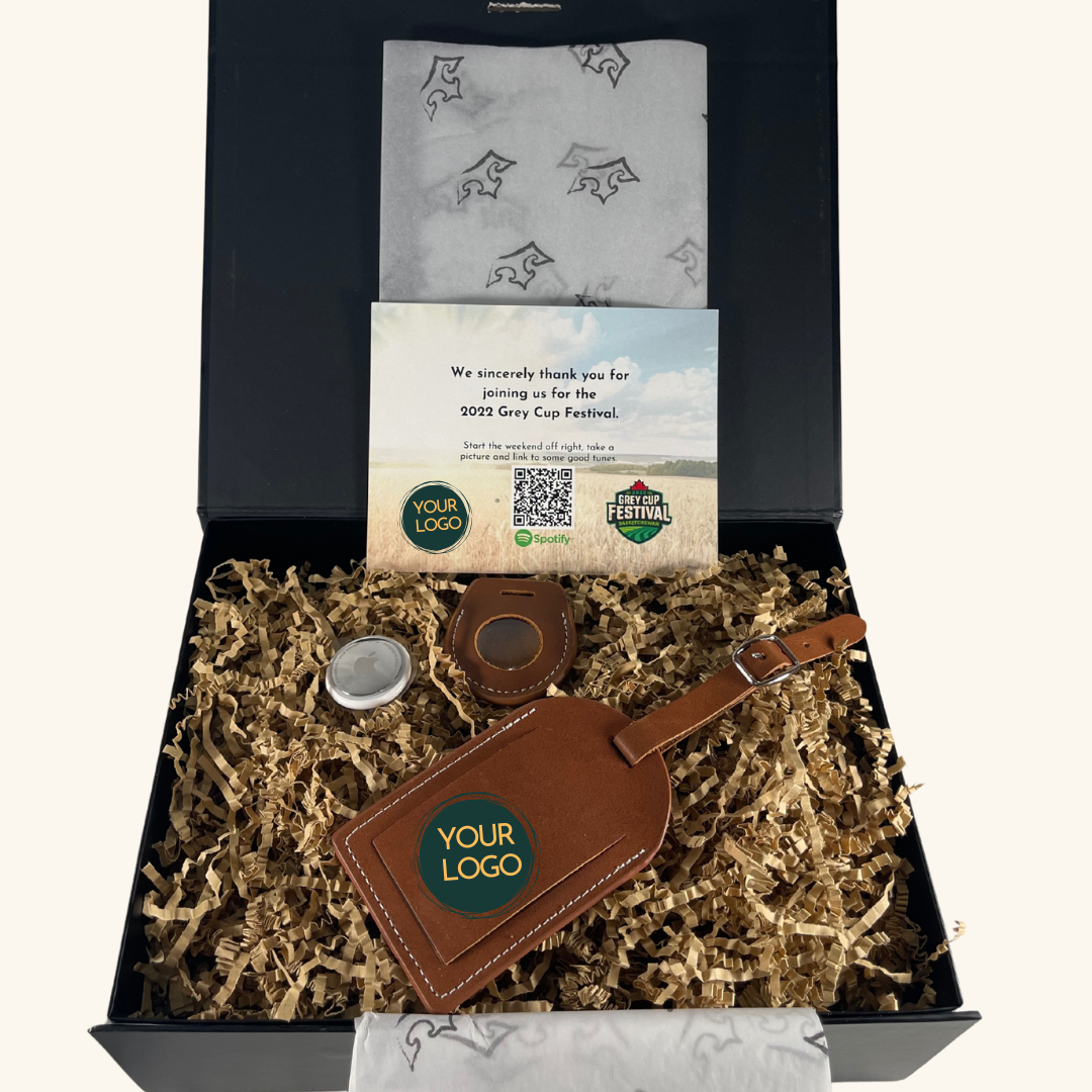 corporate gift box featuring a high-quality leather luggage tag with a custom logo, an Apple AirTag, and a personalized thank-you card. 