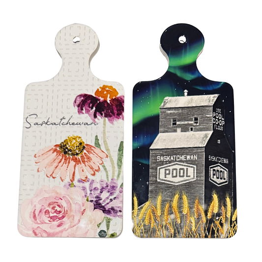 Two decorative cutting boards with floral and grain elevator designs on a white background.