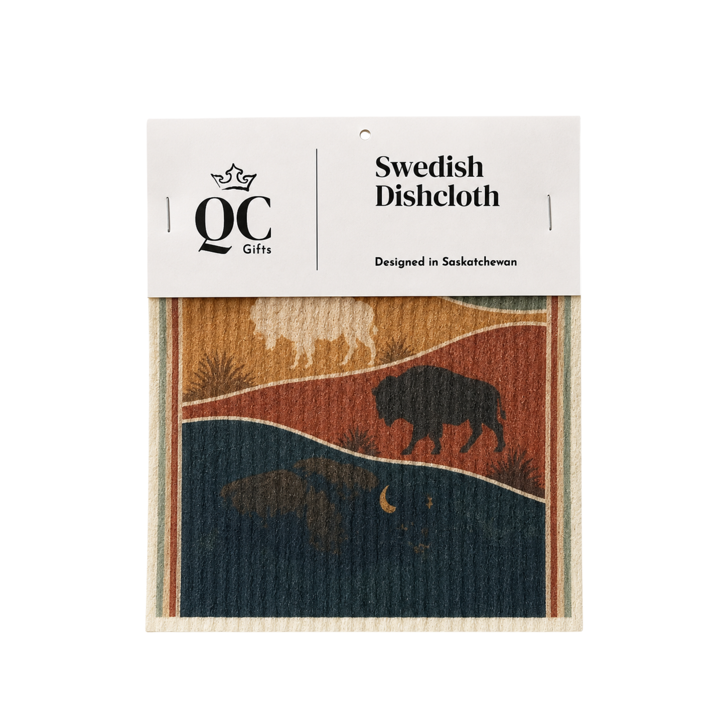 A packaged Swedish dishcloth by QC Gifts, featuring a printed design of a bison and deer in a landscape with blue, orange, and beige tones, wrapped in a white paper header.