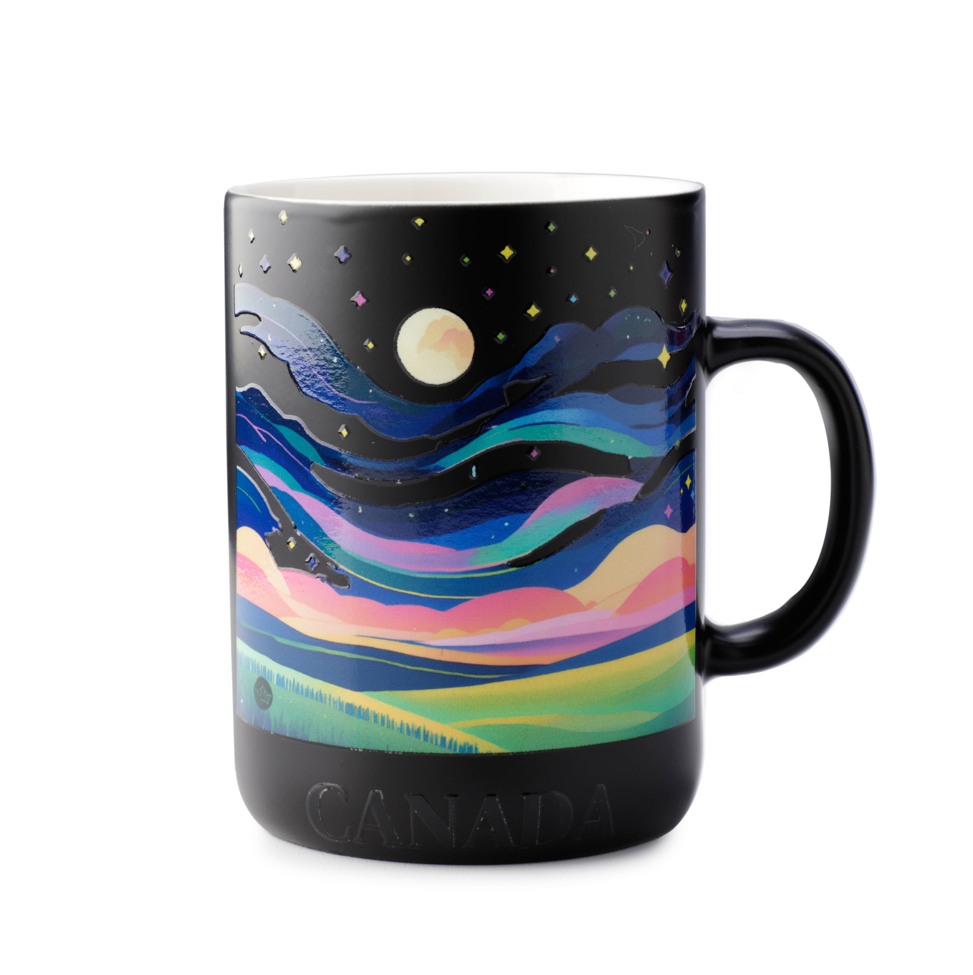 Black mug with a colorful landscape design and 'Canada' text on a white background