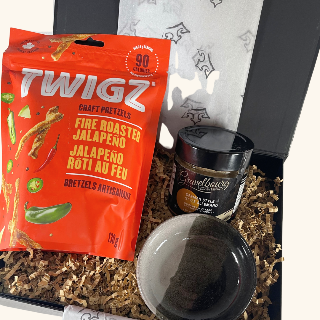 A handcrafted Freba Pottery dipping bowl filled with Gravelbourg mustard, accompanied by crisp artisan pretzel sticks—ideal for snacking and entertaining.