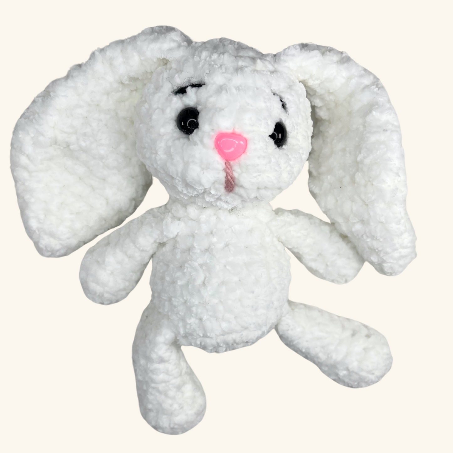 "A group of four hand-crocheted bunnies in soft pastel colors, each with unique details and adorable expressions. Perfect for Easter and springtime gifts!"