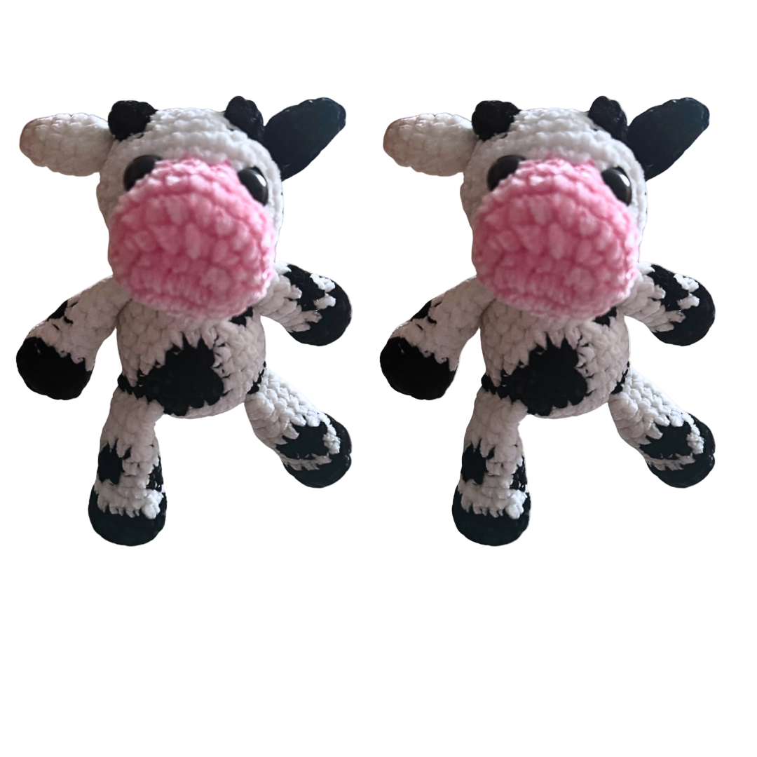 Two crochet cow toys with pink noses on a white background, featuring Connie's Crochet & Craft Corner logo.
