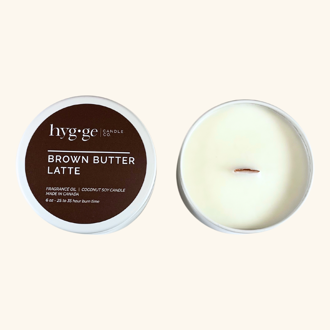 Brown Butter Latte Candle:
6 oz “Brown Butter Latte” coconut soy candle by Hygge Candle Co. in a deep brown tin, with a creamy, warm scent and wood wick.