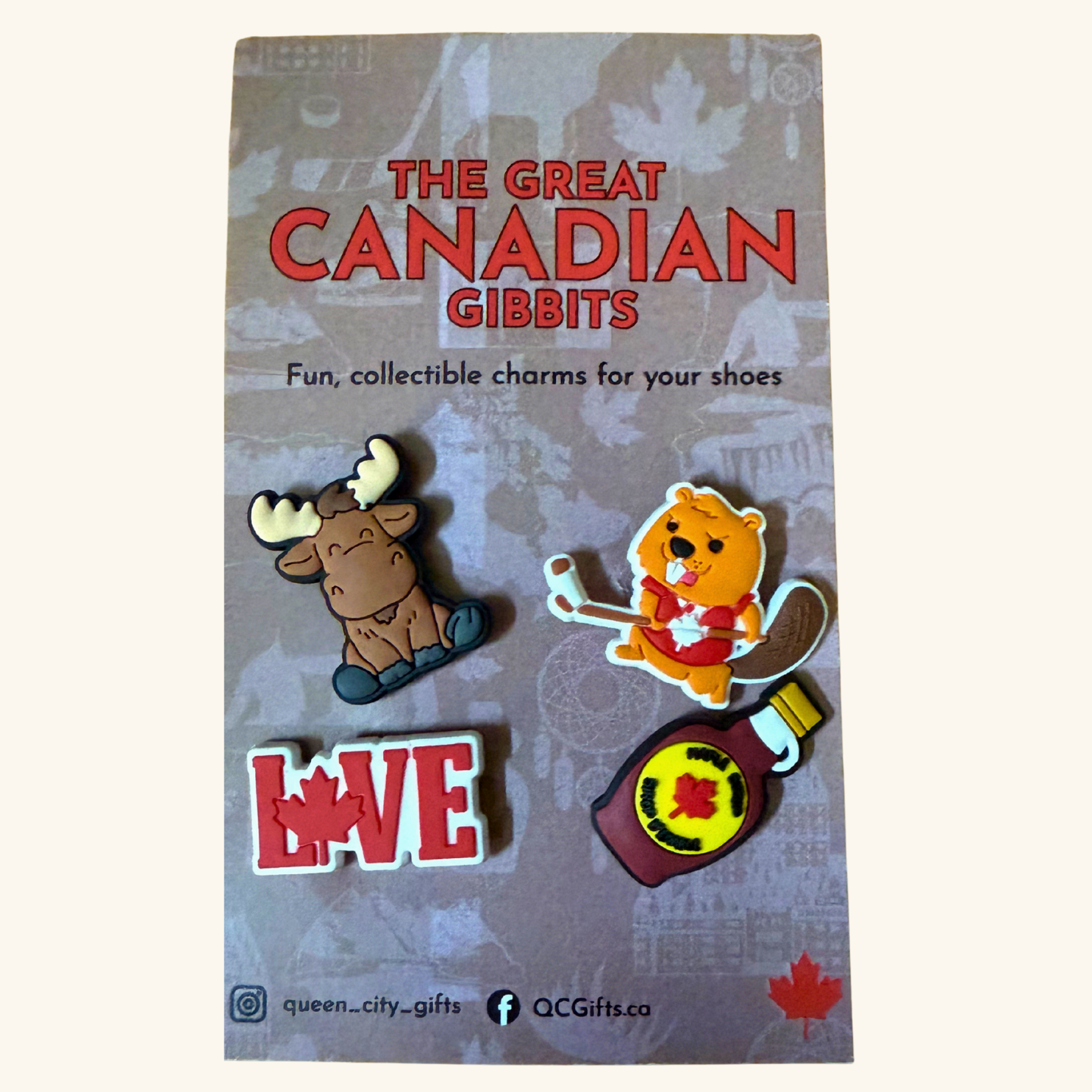 Front view of four Canadian-themed Gibbit charms on retail packaging