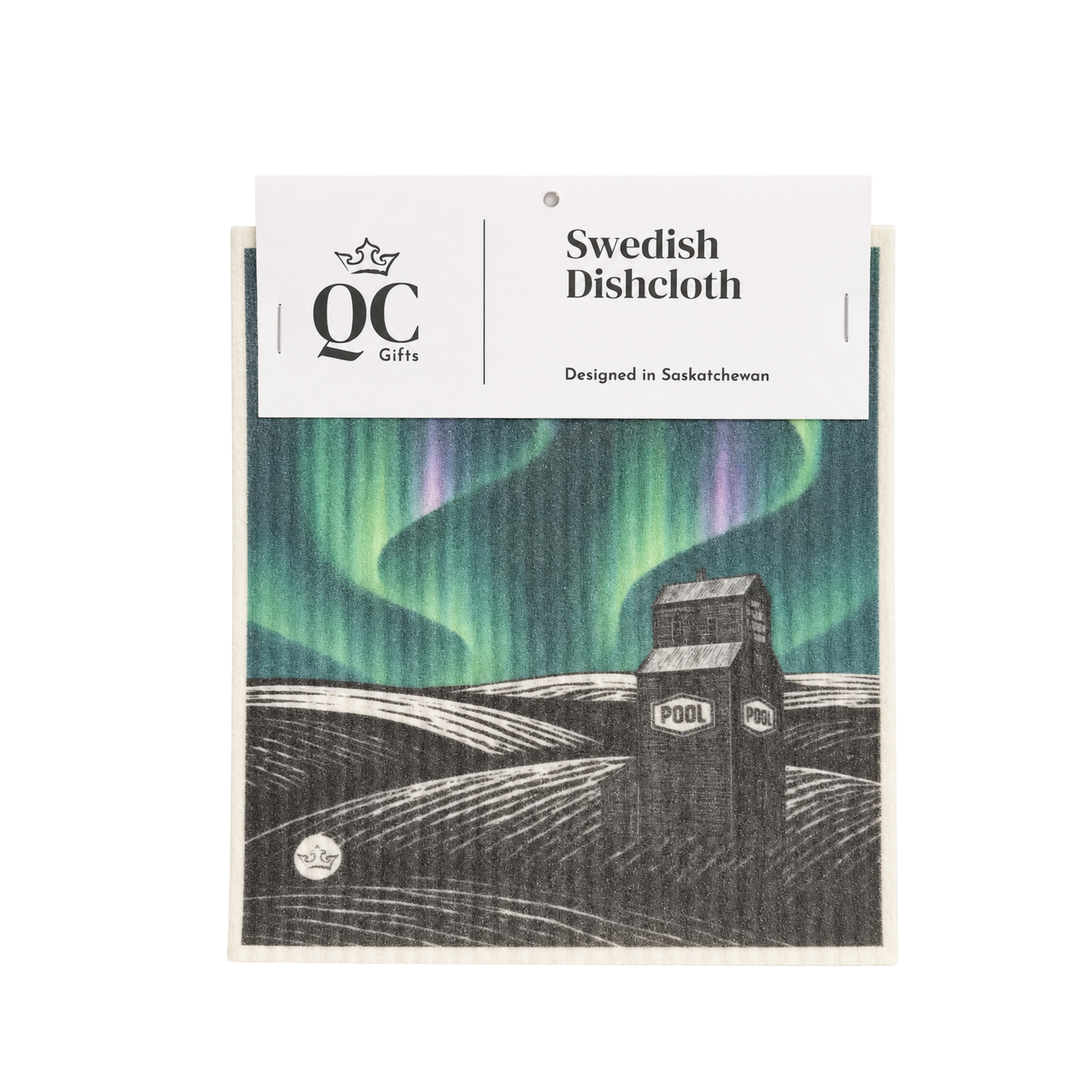 A packaged Swedish dishcloth with a printed illustration of the northern lights over a black-and-white house scene. The white header card reads 'QC Gifts' and 'Swedish Dishcloth.