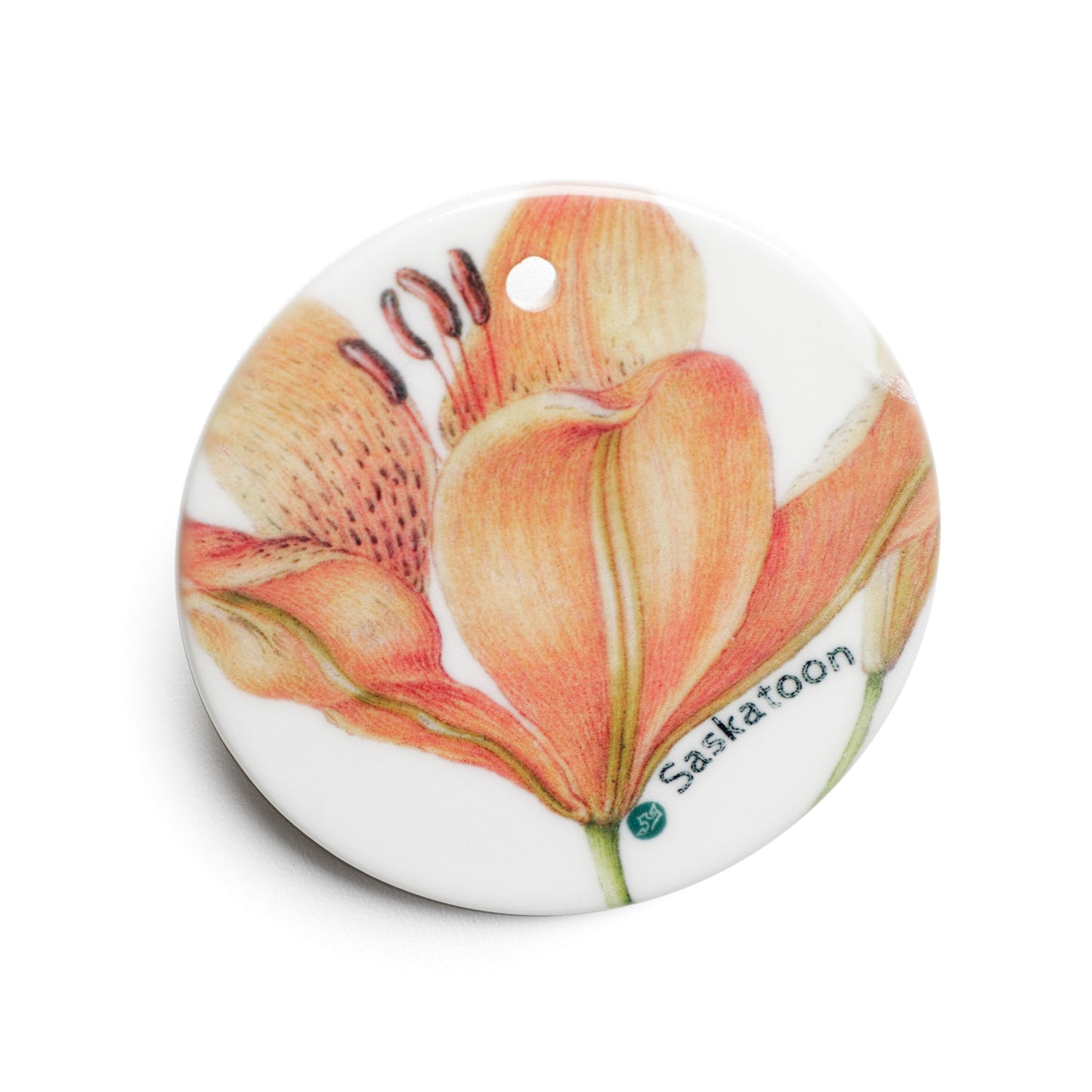 Round ceramic ornament  with a floral design and 'Saskatoon' text on a white background
