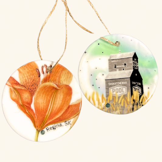 Our Ceramic Ornaments are perfect for adding a touch of elegance to your decor. These handcrafted ornaments showcase intricate designs and quality craftsmanship. Celebrate regional charm with our custom prairie ornaments.

Details:

Ceramic Ornaments are perfect for adding a touch of elegance to your decor.
Intricate designs and quality craftsmanship.
Choose from two unique designs:&nbsp;

1) Prairie Lily, Saskatchewan's beloved flower,

2) Grain elevator with a magnificent northern lights display.