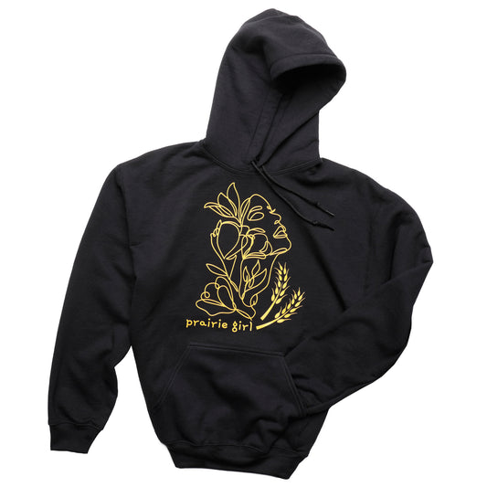 Black hoodie with gold floral design and 'prairie girl' text on a white background