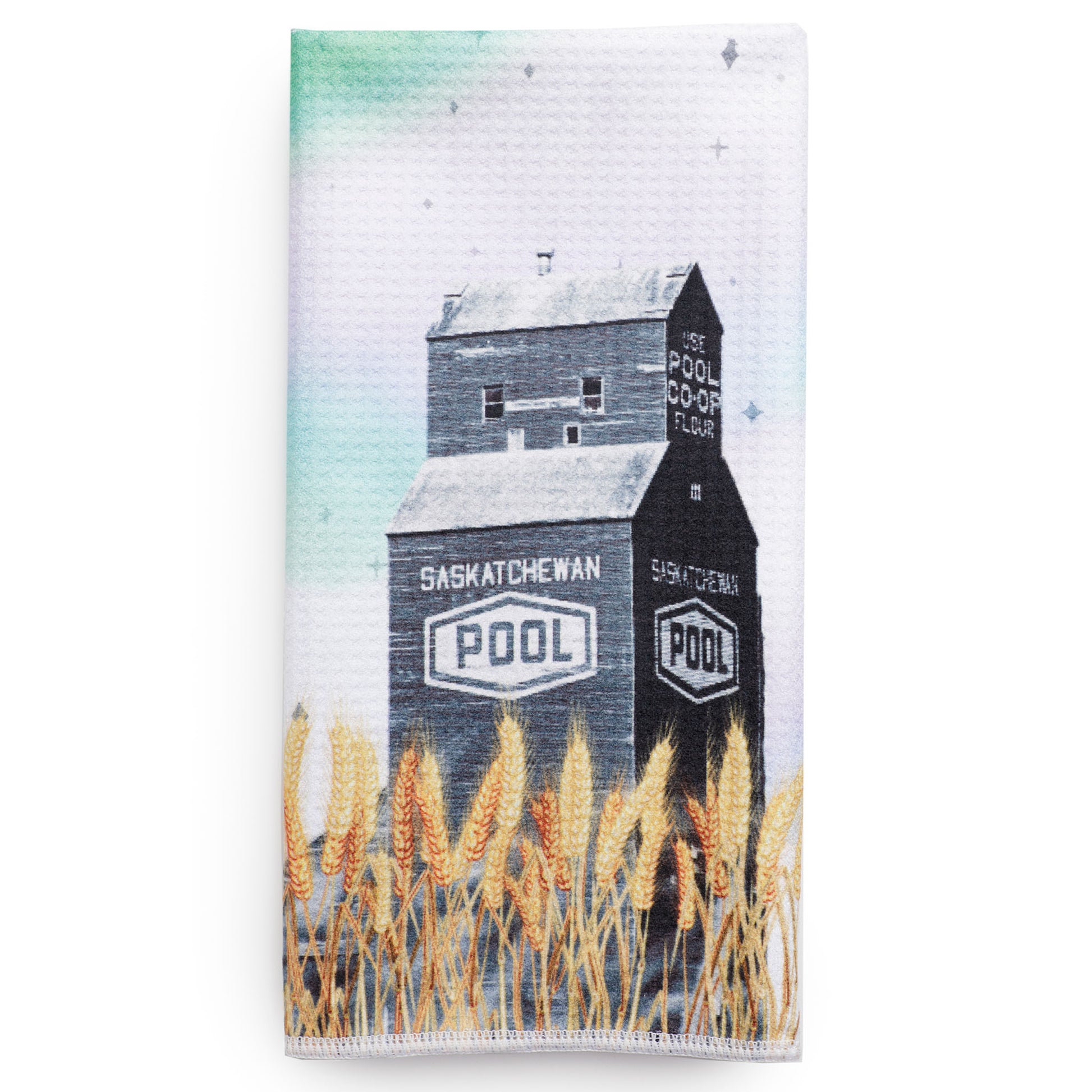Tea towel with a design of a grain elevator and wheat field, featuring the 'Saskatchewan Pool' branding.