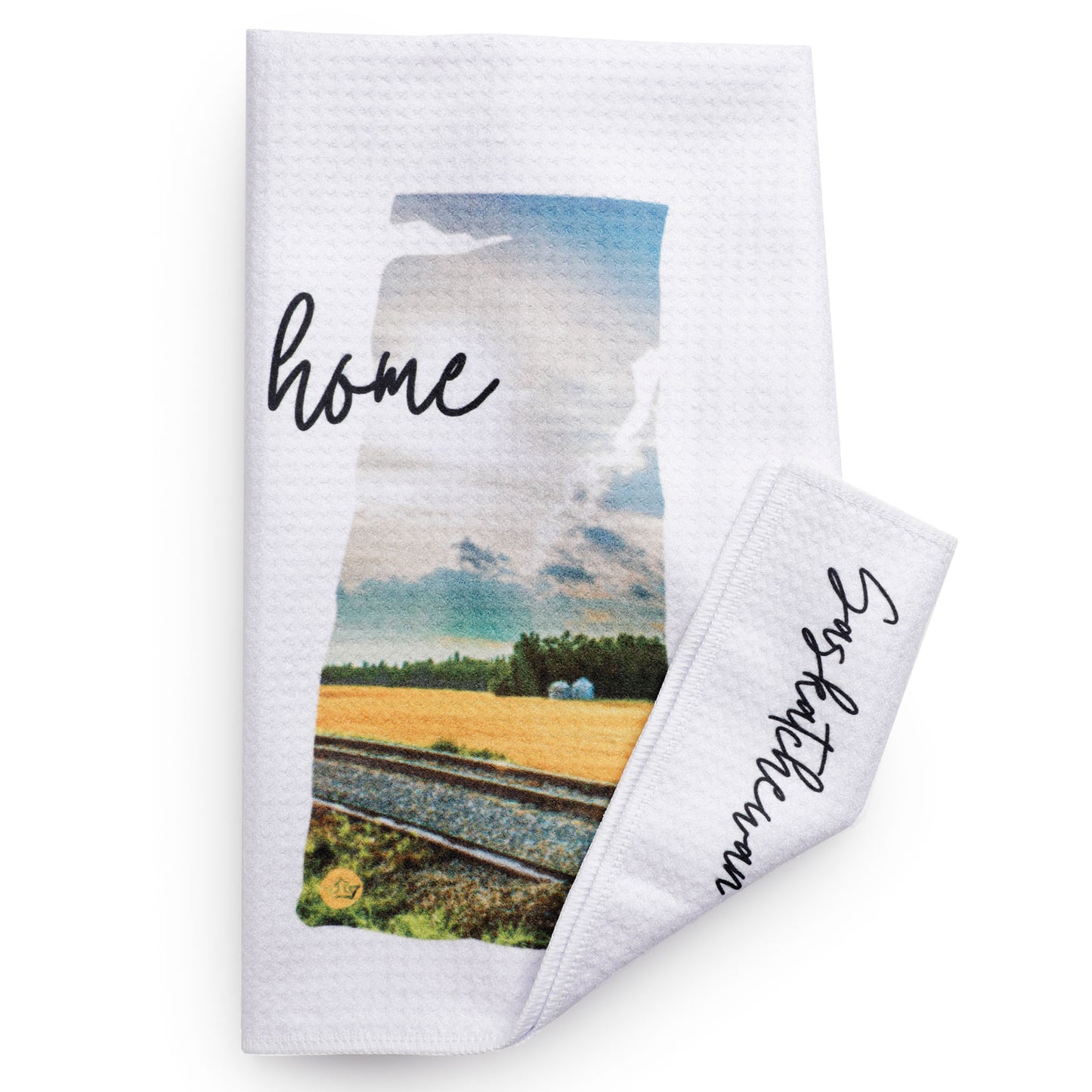 White towel with a scenic print and 'home' text on a white background