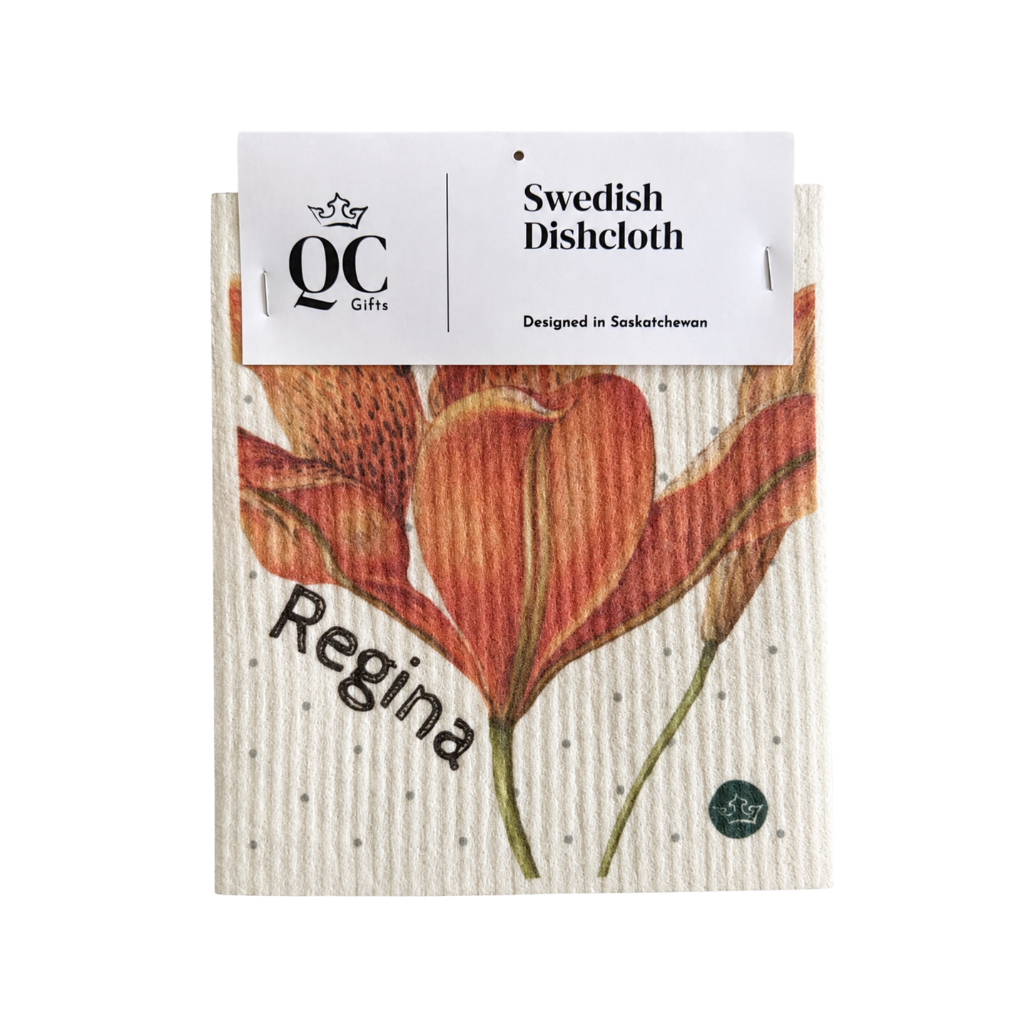A personalized Swedish dishcloth from QC Gifts featuring a watercolor-style orange lily and the name 'Regina' printed on it, with a white paper header card attached at the top.