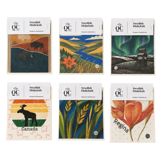 Six wooden Swedish dishcloths with printed nature-themed designs are arranged in a 2x3 grid on a white background. The designs include a bison, a landscape with a red maple leaf, the aurora borealis, a moose against a sunset, wheat stalks, and a red flower, with some featuring the names Canada and Regina.