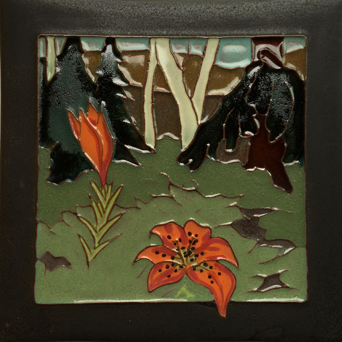Decorative tile with orange lillies flowers and black birds on a green background