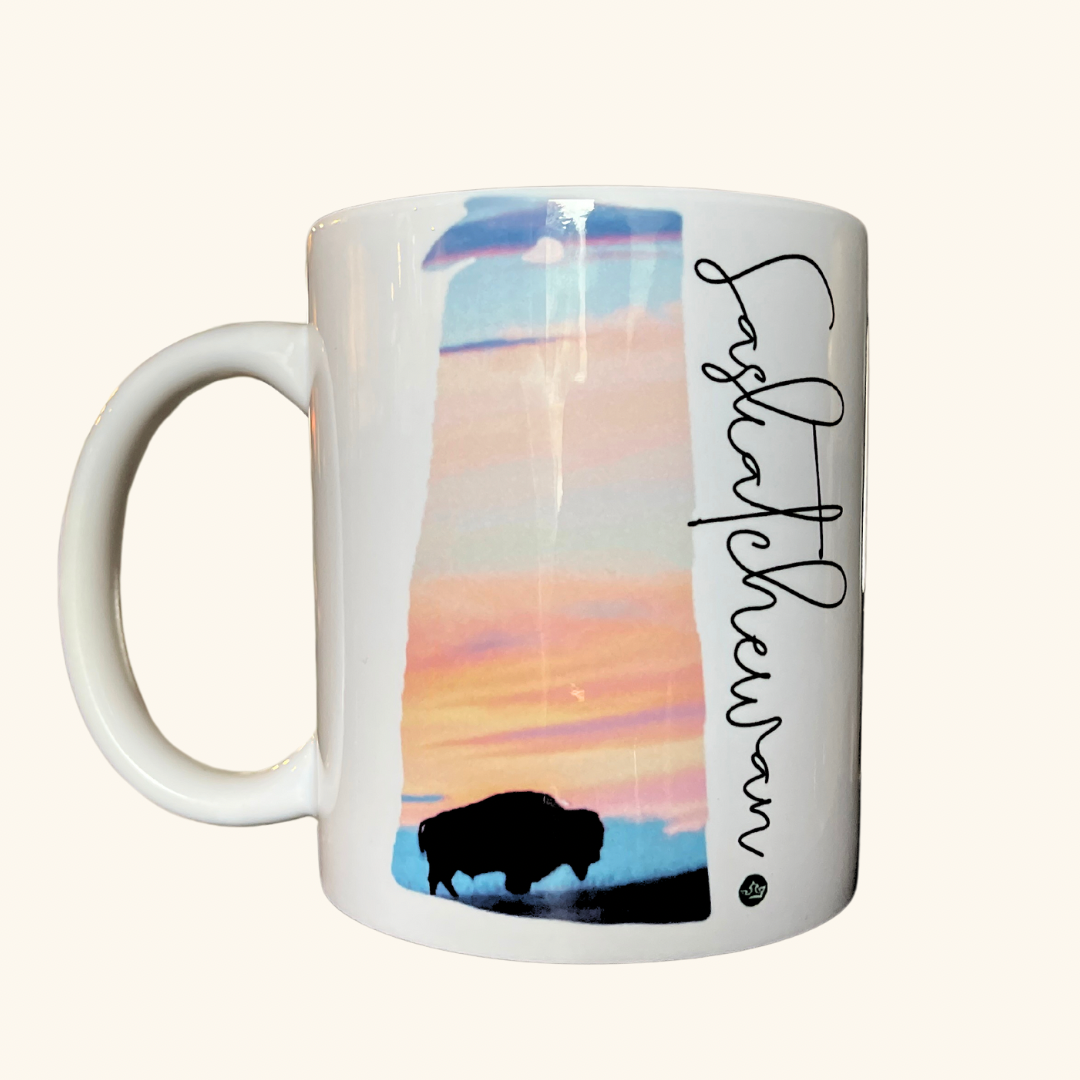 Saskatchewan Bison Sunset ceramic mug, featuring a silhouette of a bison against a Prairie sunset, crafted for coffee and tea lovers.