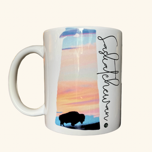 Saskatchewan Bison Sunset ceramic mug, featuring a silhouette of a bison against a Prairie sunset, crafted for coffee and tea lovers.