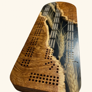 Close-up of the intricate details and high-quality wood craftsmanship on Derevo Designs' cribbage board.