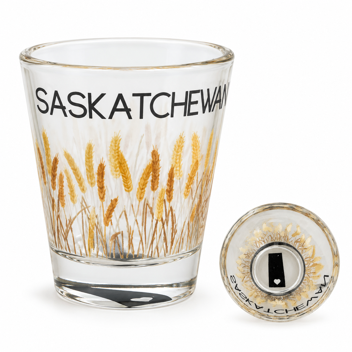 Saskatchewan 1 oz shot glass with golden wheat artwork and an inset showing the province silhouette and heart in its base.
