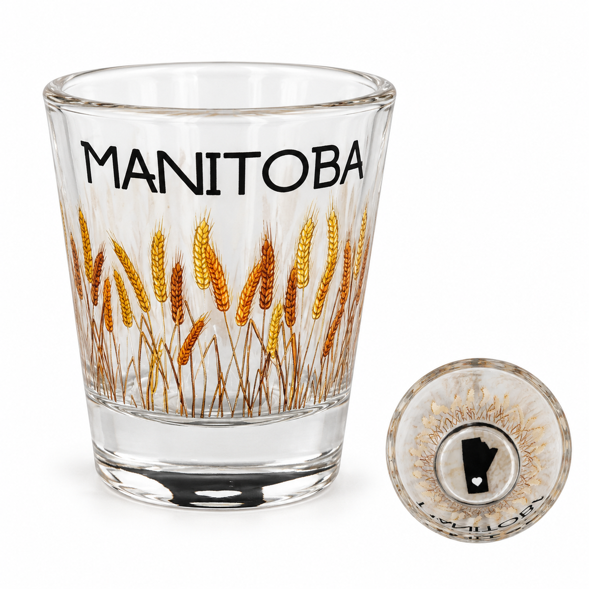 Manitoba 1 oz shot glass with golden wheat artwork and an inset showing the province silhouette and heart in its base.