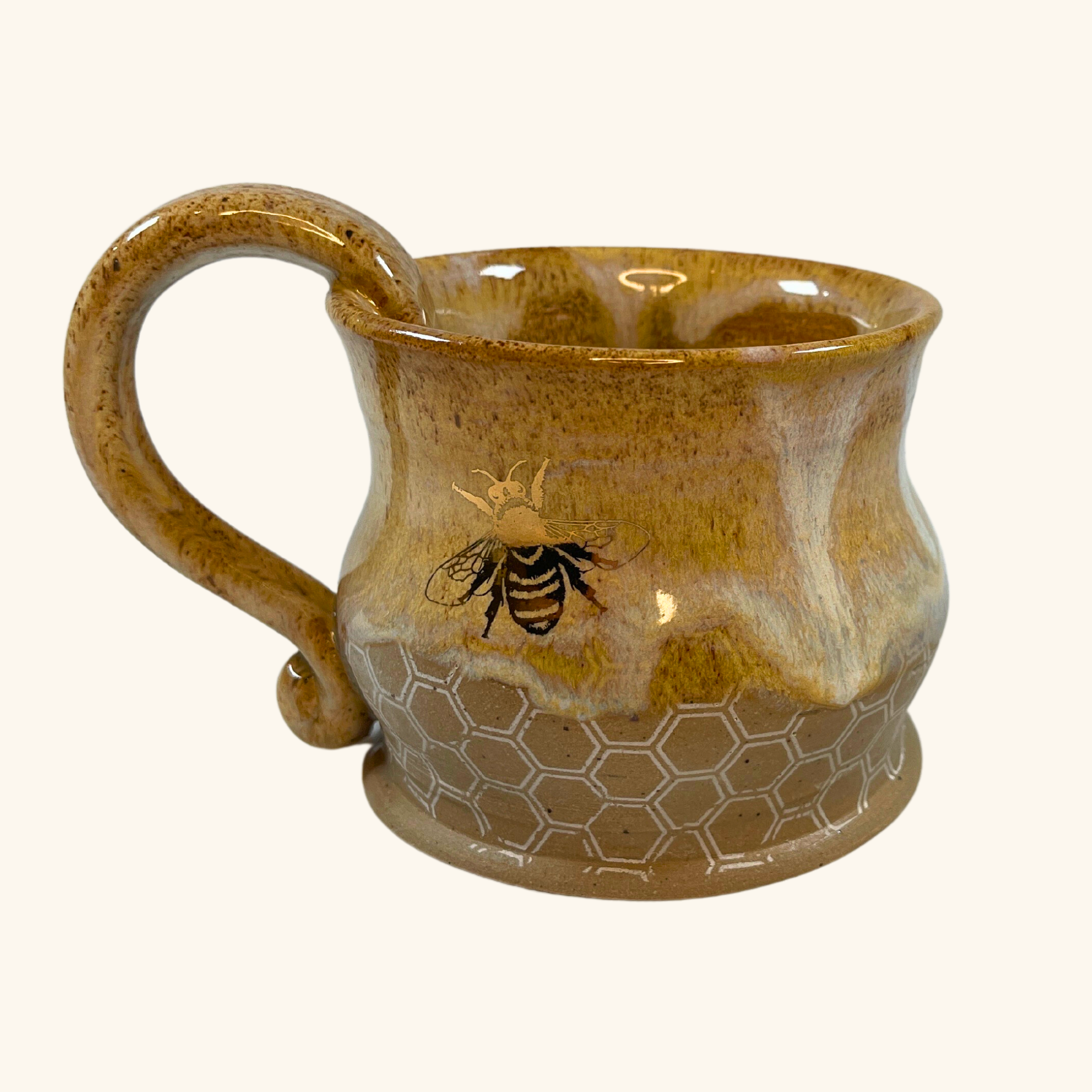 Handmade ceramic honey pot mug by Aiden Amina, featuring warm earthy tones, intricate honeycomb detailing, and a metallic bee design