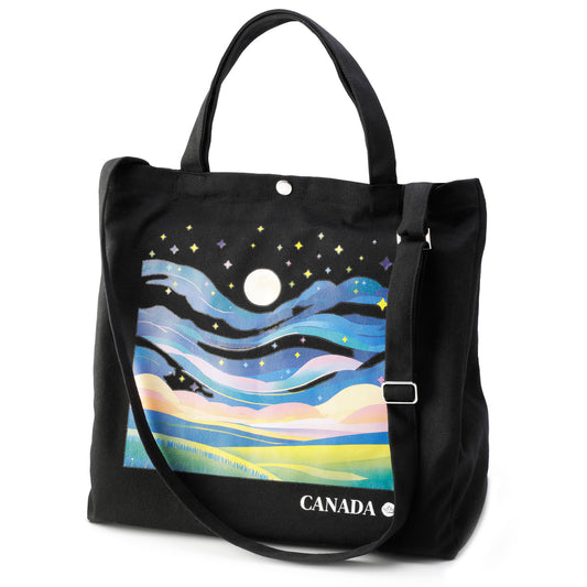 Black tote bag with a colorful landscape design and 'Canada' text on a white background