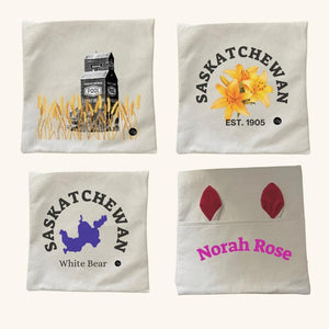 Collection of Prairie-inspired decor pillows, featuring designs of a Saskatchewan grain elevator, Prairie Lily, custom Saskatchewan lake, and personalized bunny ears pillow