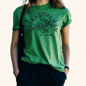 Prairie Flower T-Shirt in green, featuring a black prairie lily sketch representing Saskatchewan’s provincial flower