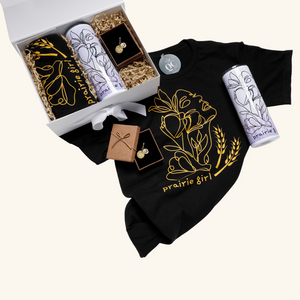 Prairie Girl Gift Box unboxed – Featuring a choice of gold or silver Prairie Girl necklace, a soft Prairie Girl t-shirt, and a double-walled stainless steel skinny tumbler