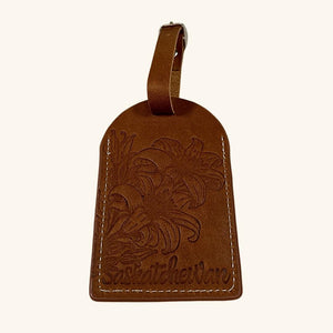 Leather luggage tag featuring an embossed Prairie Lily design, symbolizing Saskatchewan’s floral emblem.