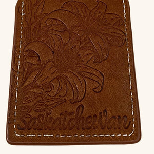 Close-up of the Prairie Lily leather luggage tag, showcasing intricate embossing and premium leather craftsmanship