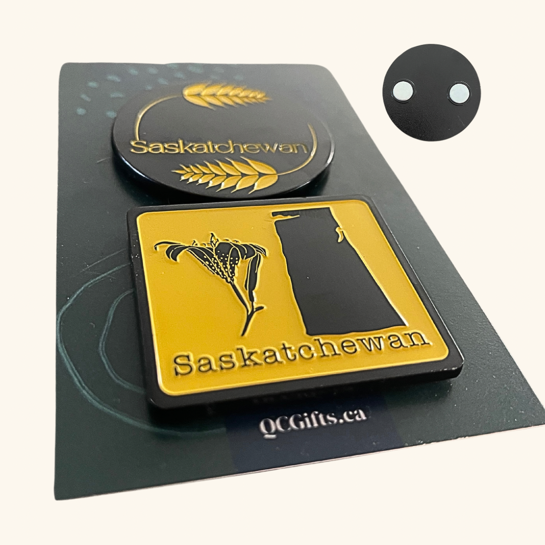 Set of two heavy-duty engraved metal magnets featuring Prairie-inspired designs: one with wheat and the other with a lily and the map of Saskatchewan