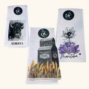 Set of three Prairie-Themed Tea Towels featuring Alberta Bison, Saskatchewan Grain Elevator, and Manitoba Crocus designs, printed on absorbent waffle fabric.