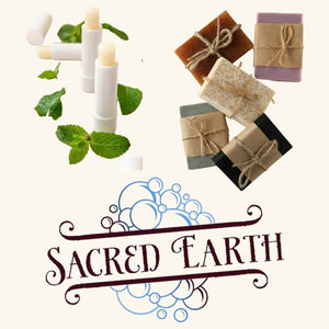 A collection of Sacred Earth Soaps' handcrafted products, including handmade soaps and nourishing lip balms, displayed elegantly