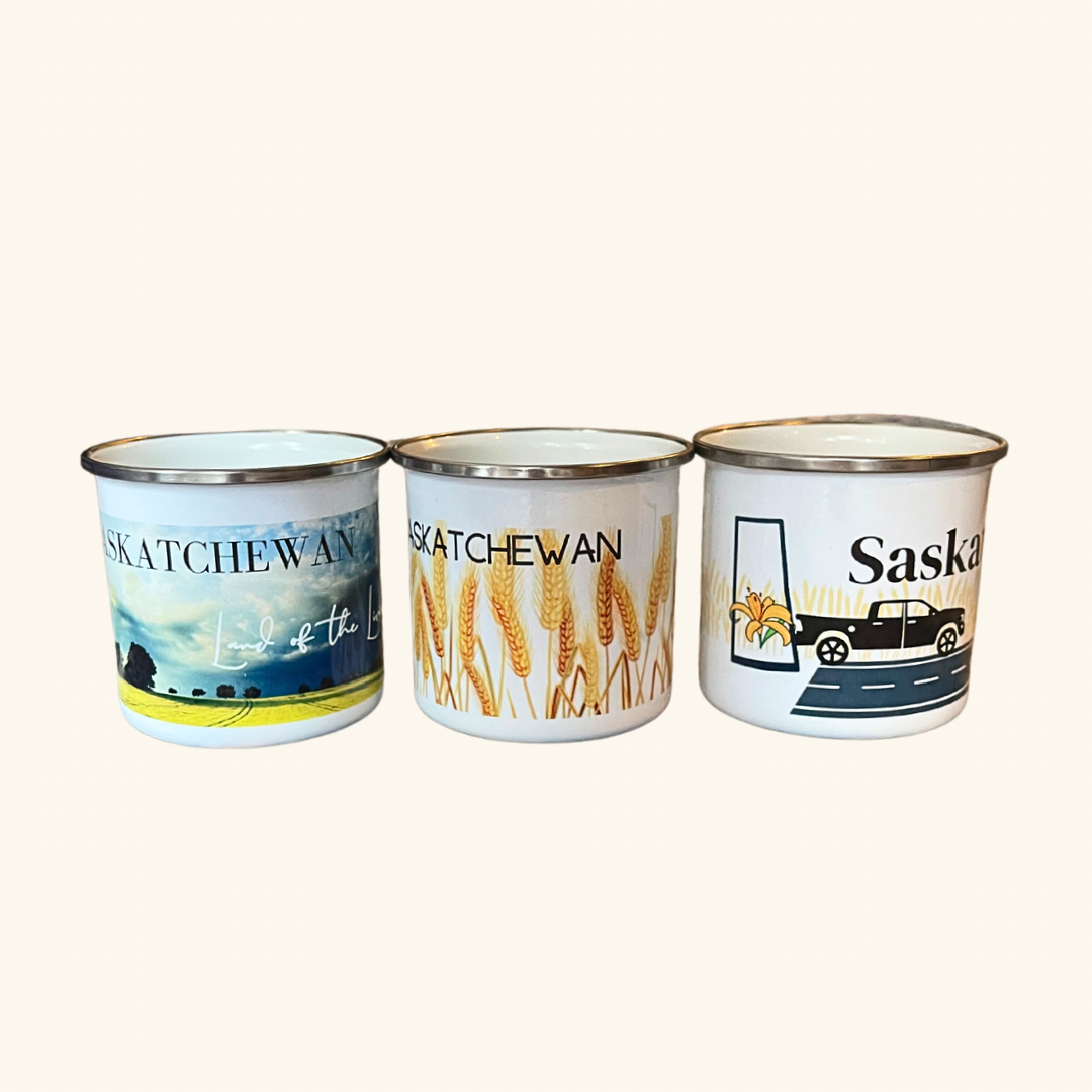 Collection of Saskatchewan Prairie Camp Mugs, featuring designs inspired by the Prairie landscape, including Land of the Living Skies, Hard to Spell Easy to Drive, and Saskatchewan Wheat Field.