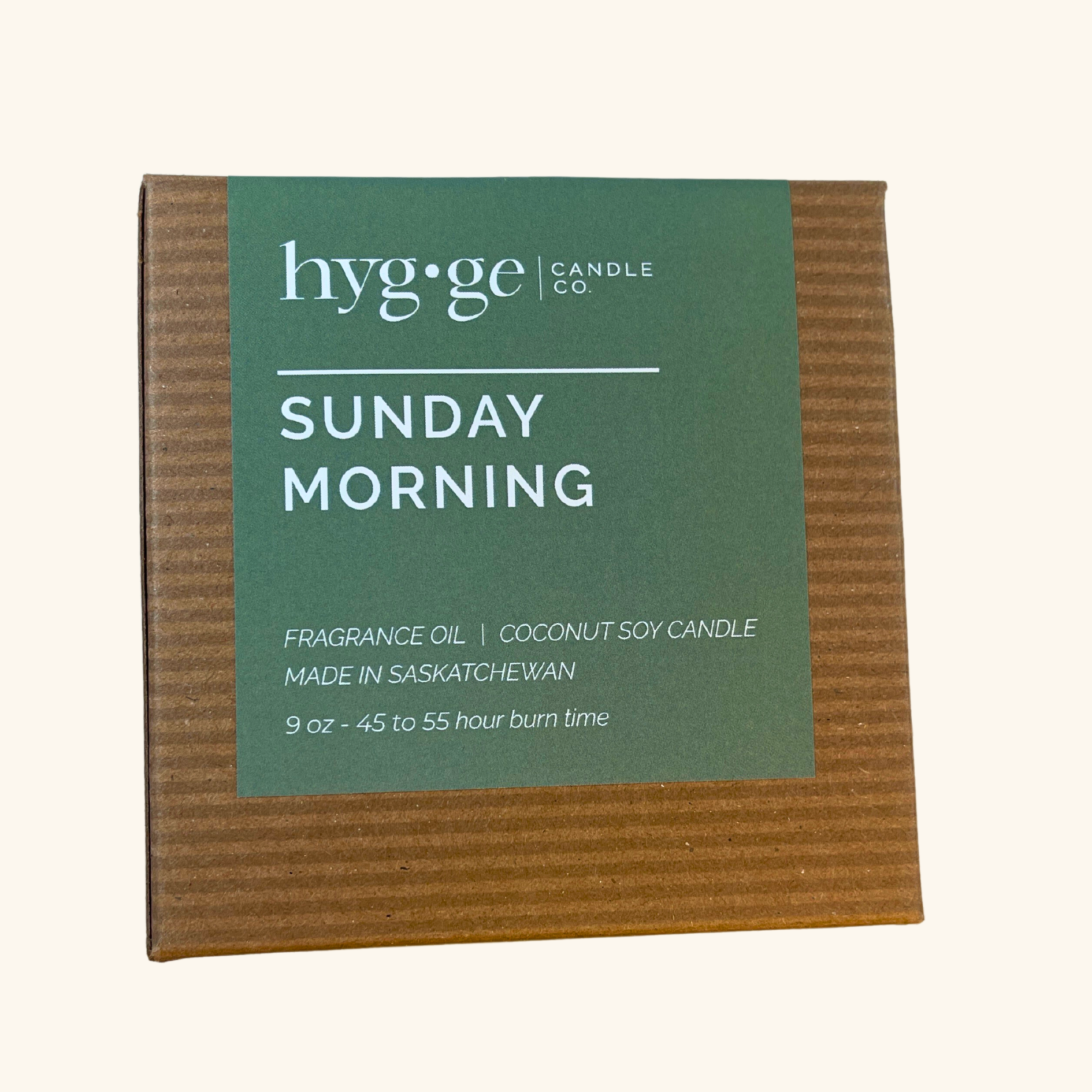 Sunday Morning Candle by Hygge, a 9oz coconut soy wax candle with notes of citrus, gardenia, lilac, and amber, designed for a refreshing burn