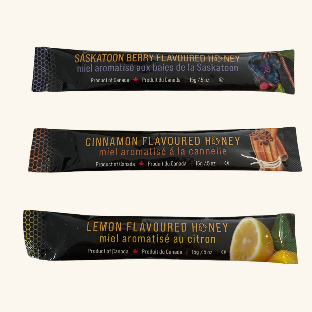 Tu-Bees Honey Sticks collection in three flavors—Cinnamon, Lemon, and Saskatoon Berry—gluten-free, nut-free, and dairy-free for mess-free sweetness on the go.